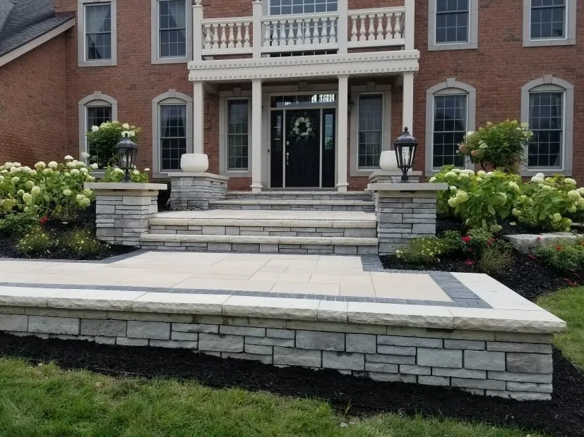 Front entrance with wide stone steps and landscaped beds