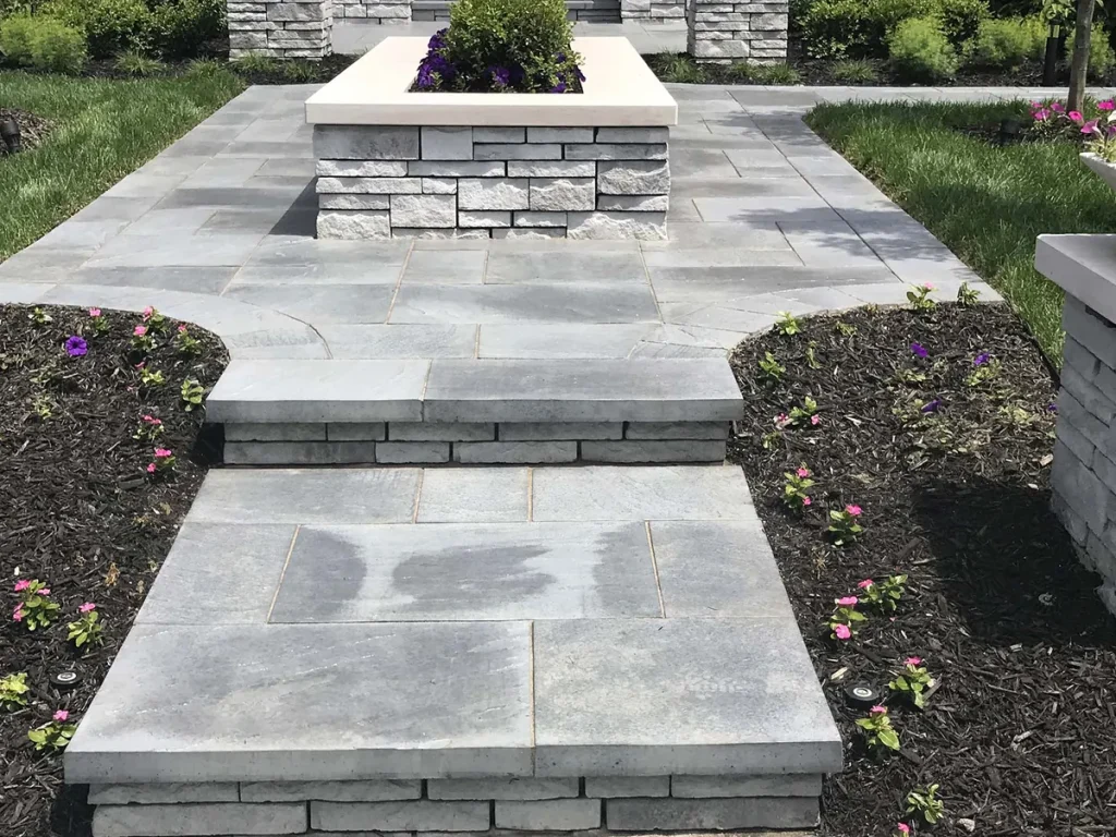 Stone slab walkway between raised planters